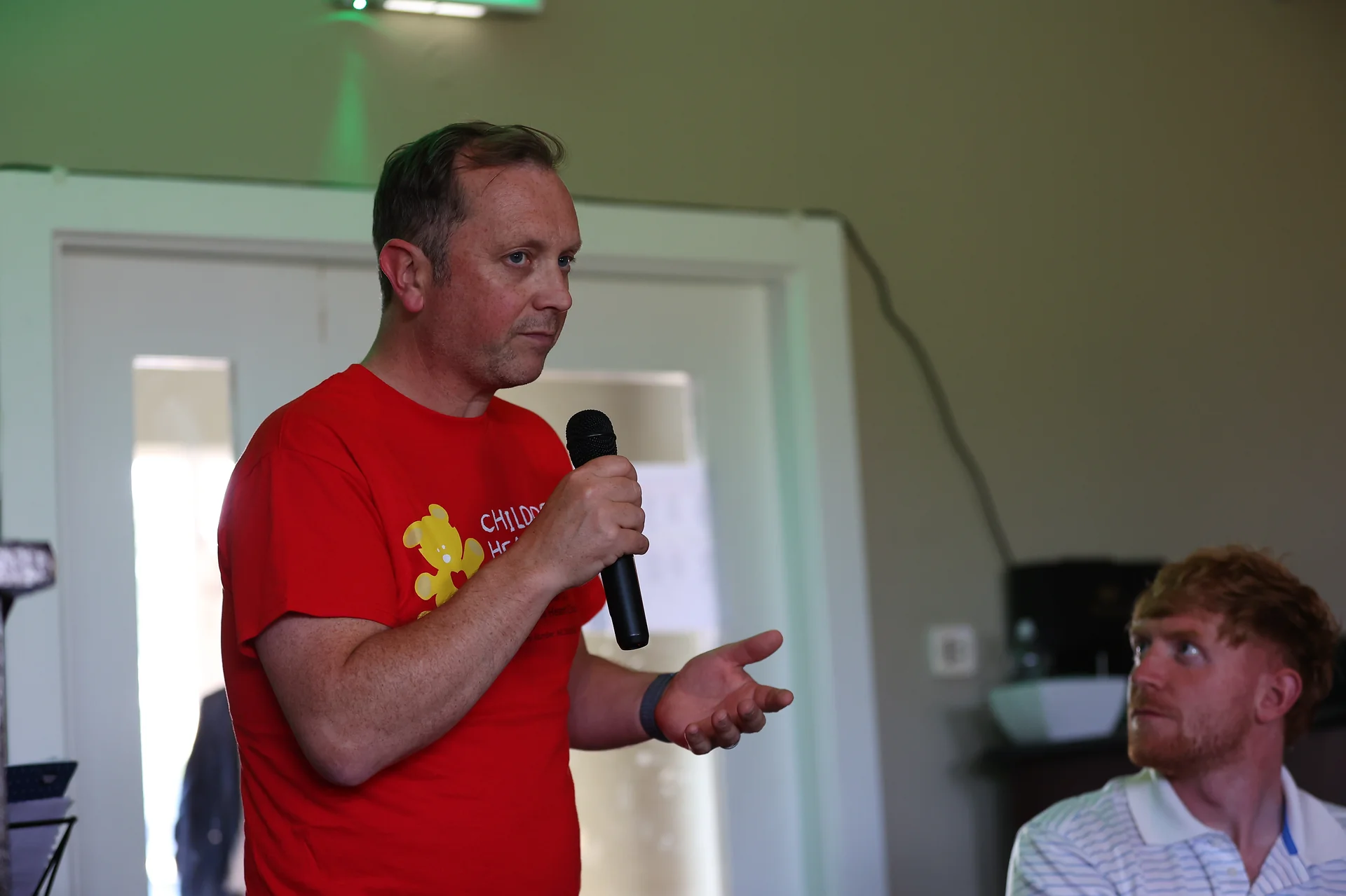 Charity representative speaking at Tech Tee Up